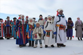 Family in traditional clothing in winter