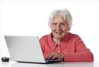 Senior sitting at the laptop