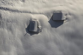 Snow-covered mountain huts in winter from above