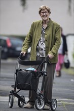 Senior citizen with walker on the street