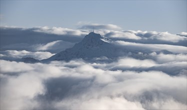 View of snow-covered Kitzbuehler Horn between clouds