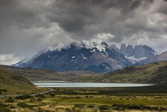 View over Lake Laguna Amarga to the mountain range Cuernos del Paine in clouds