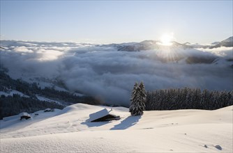 View of the Brixen Valley with morning sun and high fog in winter