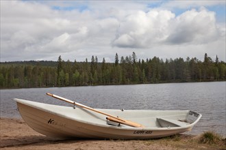 Landscape photo boat on the lake shore. Near Posio