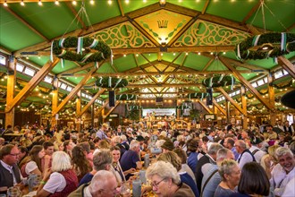 Guests sit comfortably in the festival tent