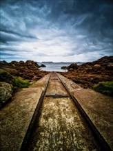 Rusty tracks into the sea
