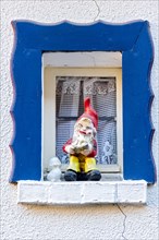 Garden gnome at small window
