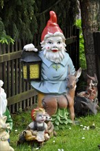 Garden gnome with lantern and deer
