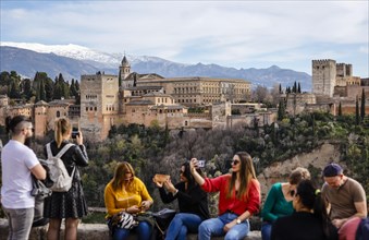 Tourists taking pictures of the Moorish city castle Alhambra