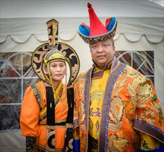 Mongolian family is posing wearing traditional costume in the DEEL