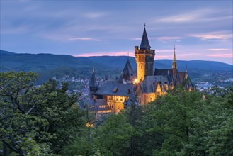View of the illuminated Wernigerode Castle in the twilight