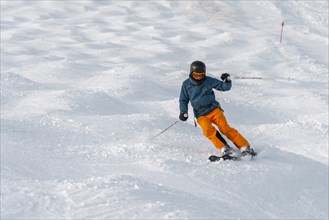 Skier on a mogul slope