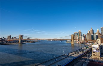 View from Manhattan Bridge over the East River to the skyline of Lower Manhattan and Brooklyn Bridge