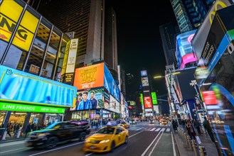 Typical yellow taxi at Times Square at night