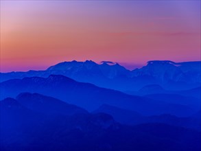 Blue mountain silhouettes at sunrise