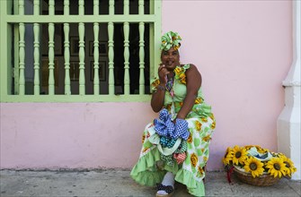 Some women in Habana Vieja wear beautifully coloured dresses and for some money readily pose for photographs