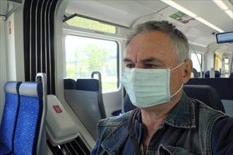 Man with face mask in the suburban train