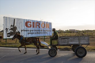 Horse cart at a propaganda billboard