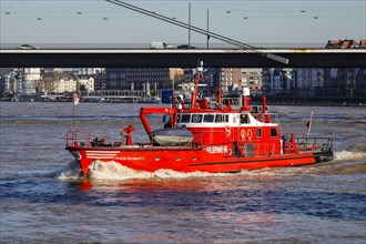 Fireboat navigates on the Rhine during floods under the Rhine knee bridge