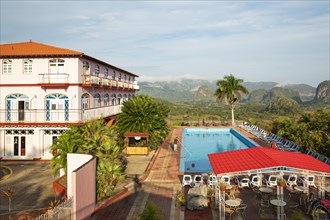 The Hotel Los Jazmines against the backdrop of the Vinales Valley with its boulder-like hills