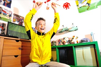 Boy at home playing computer games