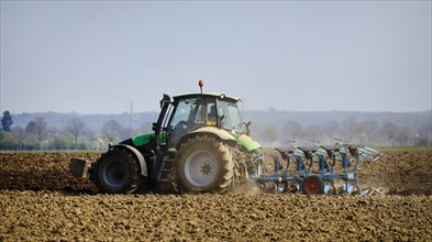 Tractor ploughs a dry field