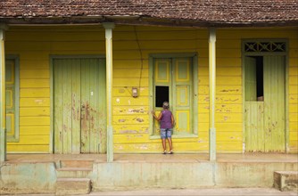 Woman at an old wooden house