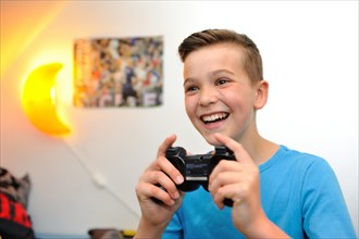 Boy at home playing computer games