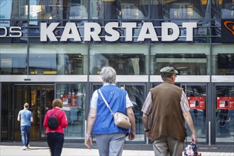 Passers-by in front of the entrance of the Galeria Karstadt Kaufhof store in the Limbecker Platz shopping centre