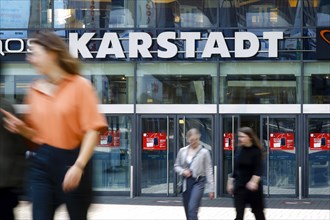 Passers-by in front of the entrance of the Galeria Karstadt Kaufhof store in the Limbecker Platz shopping centre