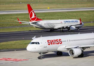 Swiss Airbus A320-214 and Turkish Airlines Boing 737-8F2 aircraft awaiting departure at Duesseldorf International Airport
