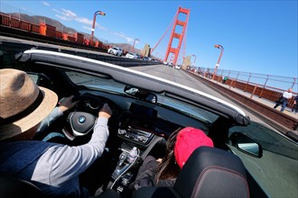 Driving over the Golden Gate Bridge in a convertible