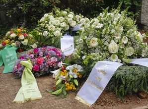 Mourning wreaths with ribbons on a fresh grave