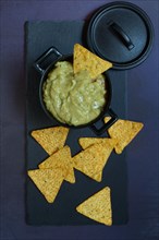 Guacamole in pot and tortilla chips
