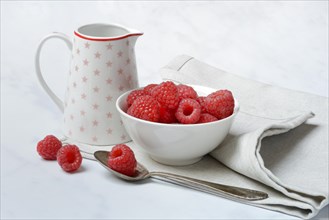 Bowl with raspberries and pot