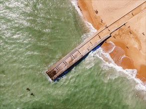Aerial view of pier and sandy beach