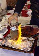 Testi Kebab is served with fire in a restaurant