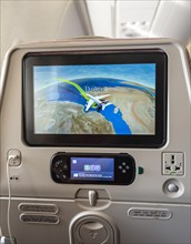 Screen showing flight position Dubai on backrest in aircraft