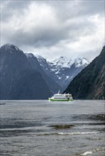 Tourist boat goes through Milford Sound