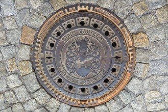 Manhole cover with the coat of arms of the city of Bautzen