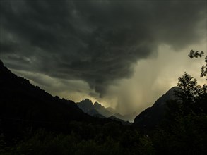Thunderstorms and rain clouds over mountain peaks