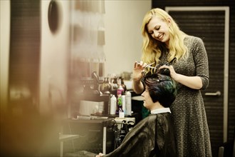Hairdresser cuts the hair of a customer in a hairdressing salon