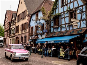 Vintage cars in front of historic half-timbered houses