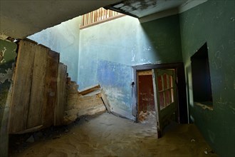 Interior view of a crumbling building in the diamond city Kolmanskop