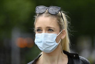 Woman wears mouth mask correctly over nose and mouth