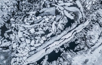 Partly frozen lake with ice floes