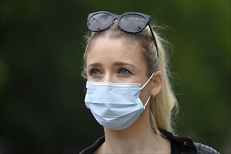Woman wears mouth mask correctly over nose and mouth