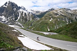Racing cyclist on the Nufenen Pass in the Swiss Alps