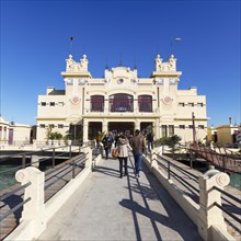 Tourists go on pier to the former bathhouse