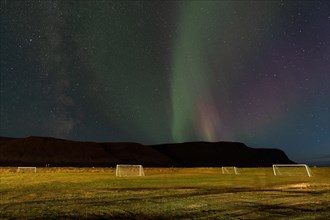 Northern Lights above the football field of the village of Talknafjoerour